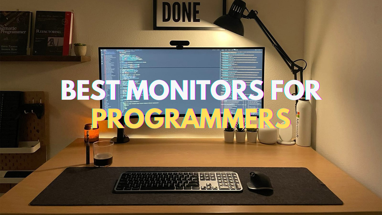 programming workspace with monitors displaying code
